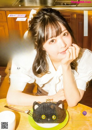 A woman sitting at a table with a plate of food.