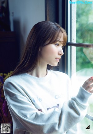 A woman in a sweatshirt on the cover of a magazine.