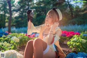 A woman in a costume holding a sword in a garden.