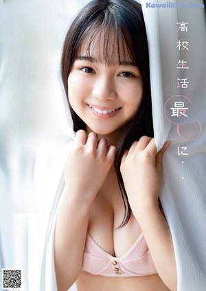 A young woman in a school uniform posing for a picture.