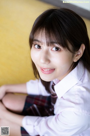 A woman in a pink shirt is posing for a picture.