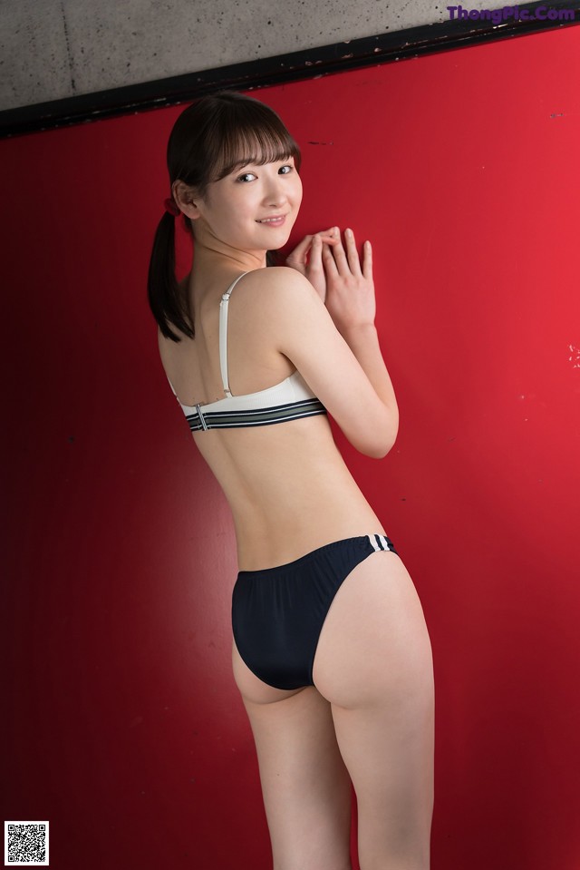 A woman in a black and white bikini posing for a picture.