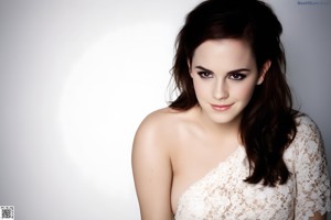 A woman sitting on a white chair holding a pink panties.