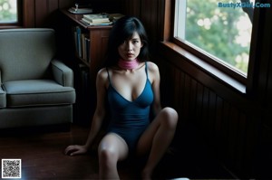 A naked asian woman sitting on a yellow chair.