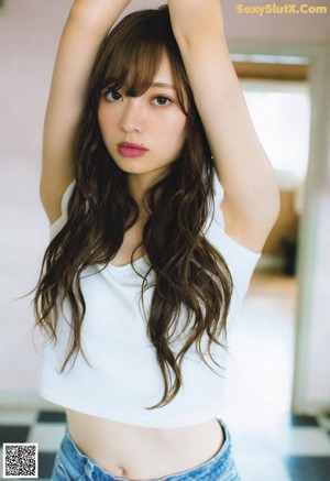 a japanese woman with long brown hair and a white shirt