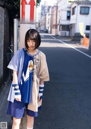 A young woman wrapped up in a blanket.